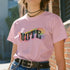 Election 2024 t-shirt with "VOTE" printed in large, colorful letters. Each letter features a different color from the rainbow spectrum, styled in a groovy 70s-inspired font.